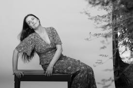 Skylar Gudasz posed on a bench in black and white. Skylar Gudasz posed on a bench in black and white.